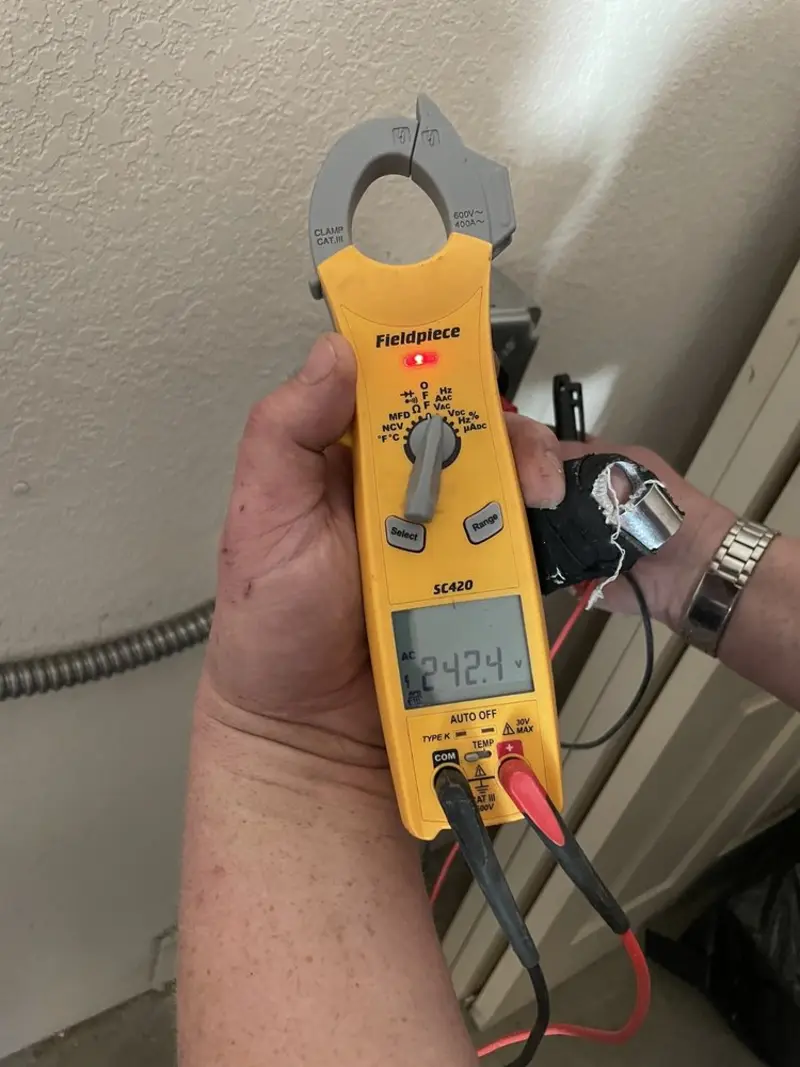 Voltage testing with clamp meter during Recessed Lighting Installation in Yulee